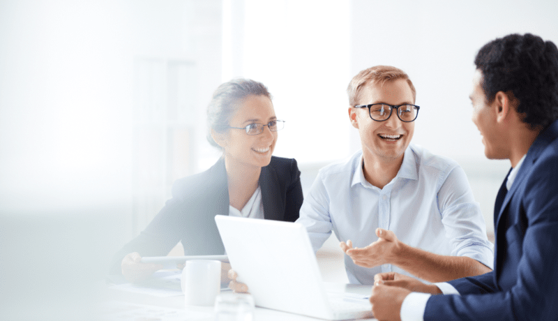 people smiling in corporate meeting